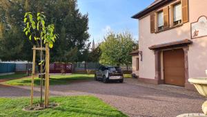 a small car parked in a driveway next to a house at La demeure Flieg in Cernay +6 photos