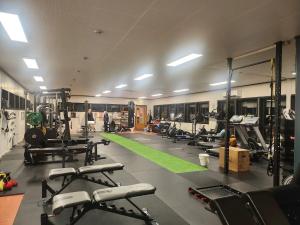 a gym with lots of machines and people in it at Yttersia Base in Senja