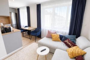 a living room with a couch and a table at ZB Apartment with Free Private Parking in Rēzekne