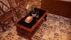 a wooden table with a box on top of a floor at EKAM in Agonda