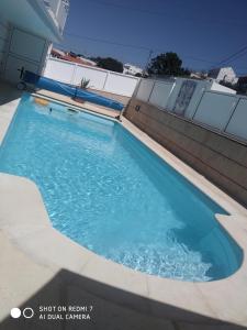 a swimming pool on the side of a building at Villa Thierry in Leiria