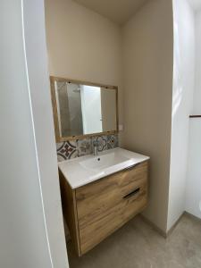 a bathroom with a sink and a mirror at Amelia in Saint-Aignan