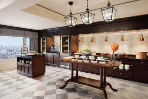 a large kitchen with a table with food on it at The Ritz-Carlton Osaka in Osaka