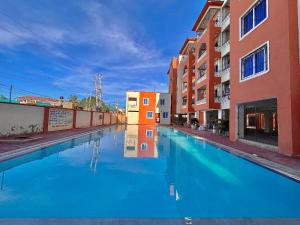 a pool of blue water in a street with buildings at Bamburi Mombasa Three bedrooms at Cutraz homes apartments 010 in Mtwapa