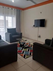 a living room with two couches and a table at Bamburi Mombasa Three bedrooms at Cutraz homes apartments 010 in Mtwapa