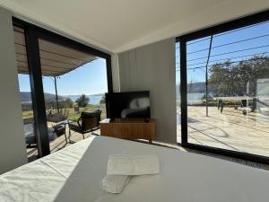 a bedroom with a bed and a large window at Auberge des Salles in Les Salles-sur-Verdon