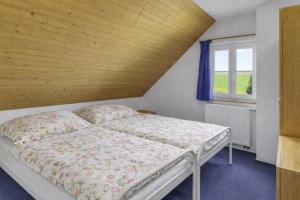 a bedroom with a bed and a window at Chata Křemenka in Lauterwasser +8 photos