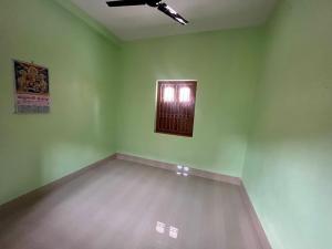 an empty room with a window in the middle of it at Radhashyam in Durgāpur