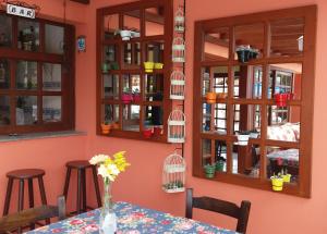 a dining room with a table and some windows at Dom Pedrito Apart Hotel in Florianópolis