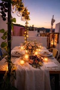 a table with candles and flowers and lights on it at Olé Toledo in Cómpeta
