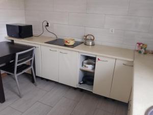 a kitchen with a counter and a sink and a table at GM Room in Altanka