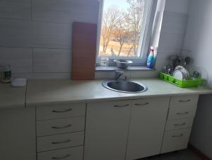 a kitchen counter with a sink and a window at GM Room in Altanka
