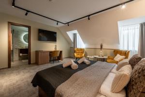a bedroom with a bed and a living room at Dolce Vita Hotel Art in Budapest