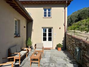 a patio with chairs and a table in front of a building at Il colle in Lucca