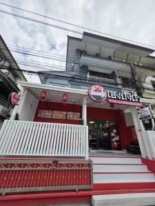 a building with red and white steps in front at Huggdaily 7 in Ban Khlong Thewa