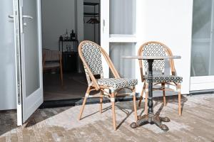 two chairs and a table in a room at Residence Paradis in Zandvoort