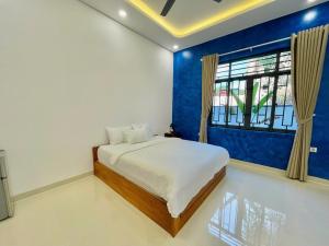 a bedroom with a large bed and a window at KIMO HOUSE Khem Beach in Phú Quốc +21 photos
