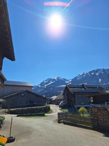 a street light over a driveway with mountains in the background at Ferienhof Muxel in Großdorf