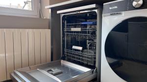 a dishwasher with its door open in a kitchen at Cocon de Charme - T2 sur Place d'Armes in Valenciennes