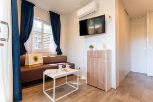 a small living room with a couch and a table at Club del Sole Rivaverde Easy Camping Village in Marina di Ravenna