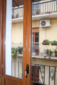 a door to a balcony with potted plants on it at SudOceania Apartment in Lamezia Terme