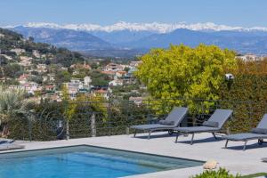 a patio with two chairs and a swimming pool at REF 2193 - Super Cannes Villa for rent in Vallauris