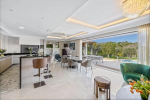 an open kitchen and living room with a table and chairs at REF 2193 - Super Cannes Villa for rent in Vallauris