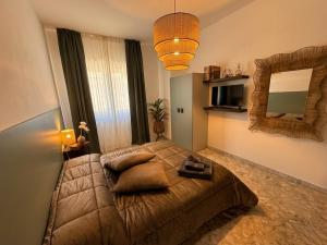 a bedroom with a large bed and a mirror at Casa della Civetta in Monopoli