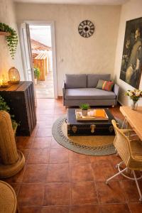 a living room with a couch and a table at Olé Toledo in Cómpeta +37 photos