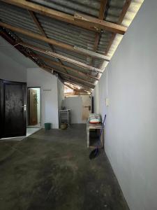 a room with white walls and a wooden ceiling at Homestay lembayung senja in Bulakbenda