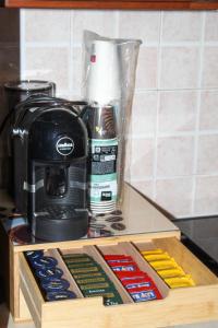 a wooden tray with a coffee maker on a counter at SudOceania Apartment in Lamezia Terme +9 photos