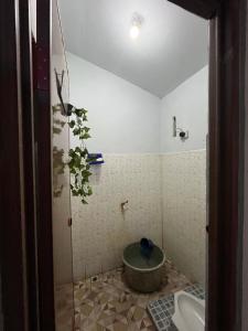 a bathroom with a shower with a toilet in it at Homestay lembayung senja in Bulakbenda
