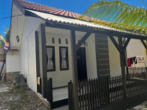 a small house with a gate and a roof at Homestay lembayung senja in Bulakbenda