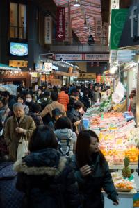 a crowd of people walking around a market with food at Stacy Annex in Kanazawa
