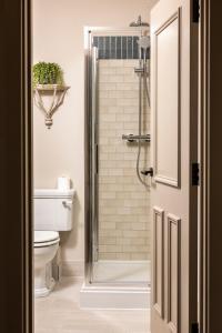 a bathroom with a shower and a toilet at Wheatsheaf Inn in Brigsteer