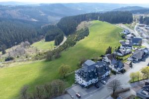 an aerial view of a large house in a green field at Astenblick Apartments Winterberg with sauna in Winterberg