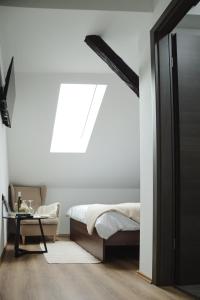 a bedroom with a bed and a window at VALLIS sobe in Požega