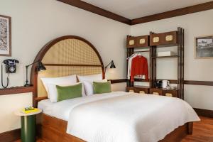 a bedroom with a large white bed with green pillows at Numa Berlin Potsdamer Platz in Berlin +46 photos