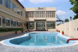 a swimming pool in front of a building at Amar Resorrt in Motīhāri