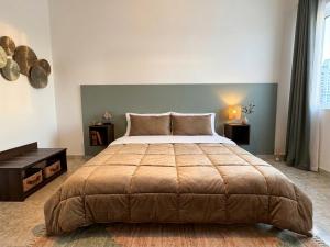 a bedroom with a large bed and a table at Casa della Civetta in Monopoli