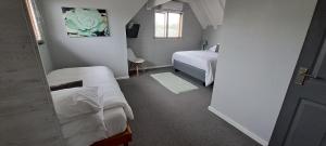 a bedroom with two beds and a window at Gables B&B Guesthouse in George
