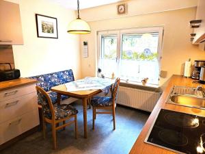 a kitchen with a table and chairs and a window at An-der-Stadtmauer in Fladungen