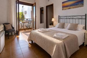 a bedroom with a large bed with two towels on it at Stella Marina Sea & Sun in Cefalù