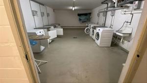 an empty room with washing machines and sinks in it at Appartementhaus Ostseeresidenz in Heiligenhafen