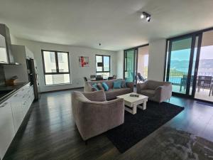 a living room with two couches and a table at Korcula Holiday in Korčula