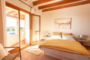 a bedroom with a bed and a large window at Idyllische Natur-Finca mit 12m Pool & Meerblick in Porto Cristo +89 photos