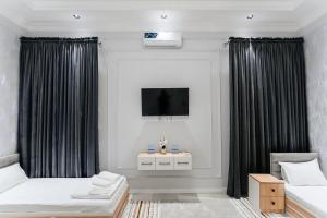 a bedroom with two beds and a flat screen tv at Classic Hotel Samarkand in Samarkand