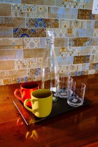 a table with cups and a bottle on a tray at Centri Villa in Anuradhapura +42 photos