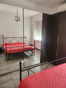 a bedroom with a red bed and a mirror at BINARIO ZERHO Luxury Apt in Rho