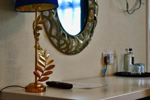 a table with a lamp and a mirror on it at Royal Sportsman Hotel in Porthmadog +112 photos